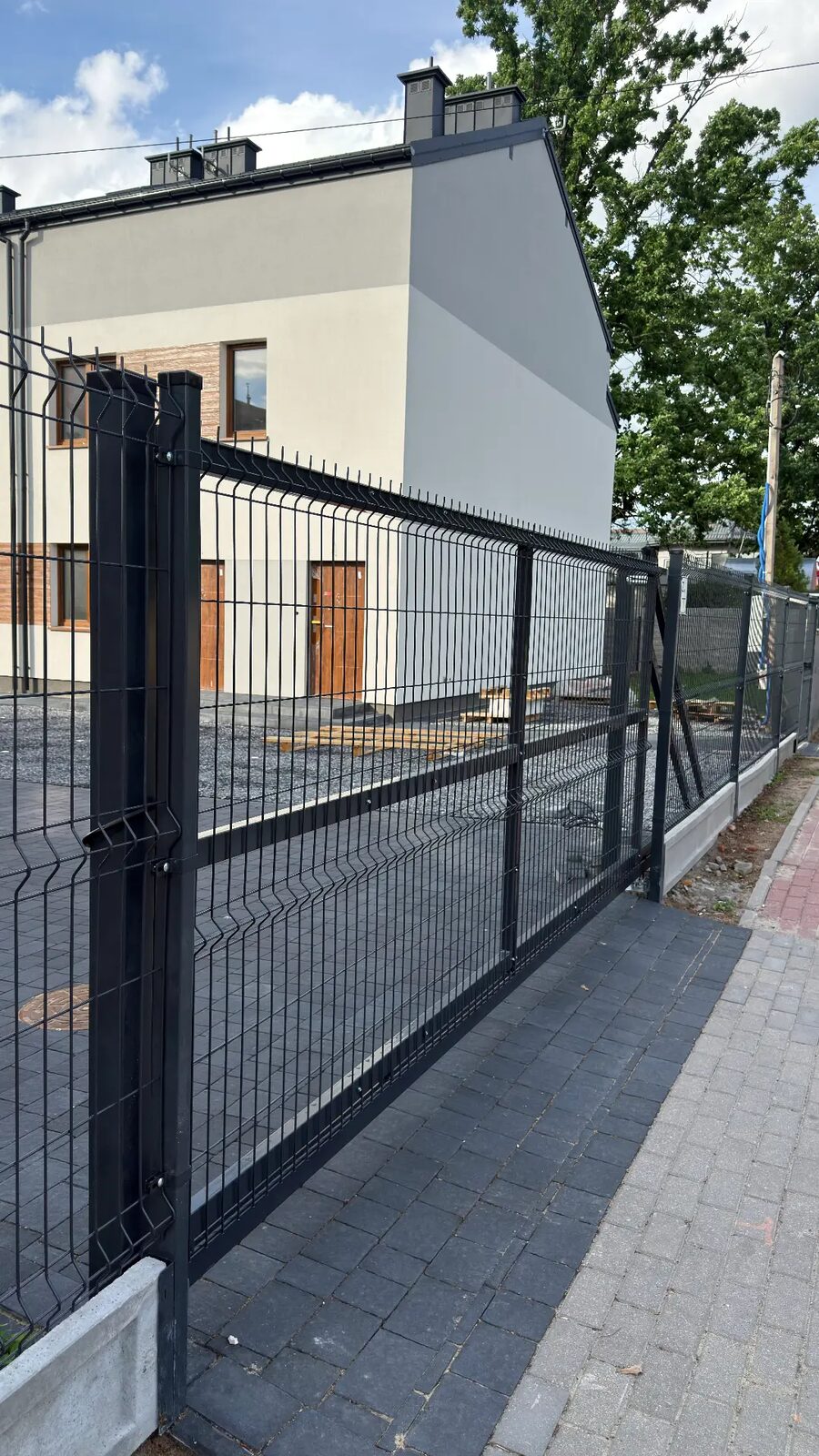 Ogrodzenie z paneli 3D na betonowej podmurówce przy nowym domu